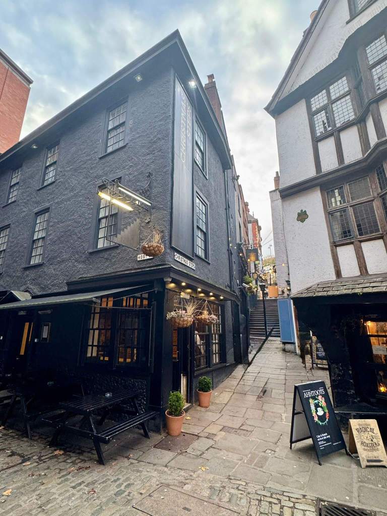 A rendered pub with a set of steps leading to it in the background.