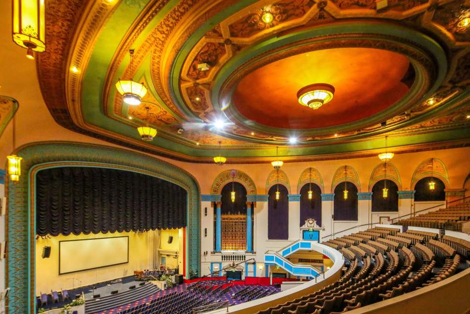View of a historic cinema interior with an ornate ceiling.
