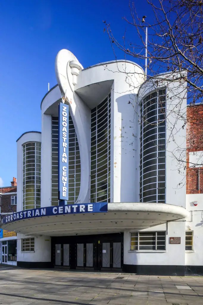 The exterior of a former historic cinema with a sweeping art deco design.