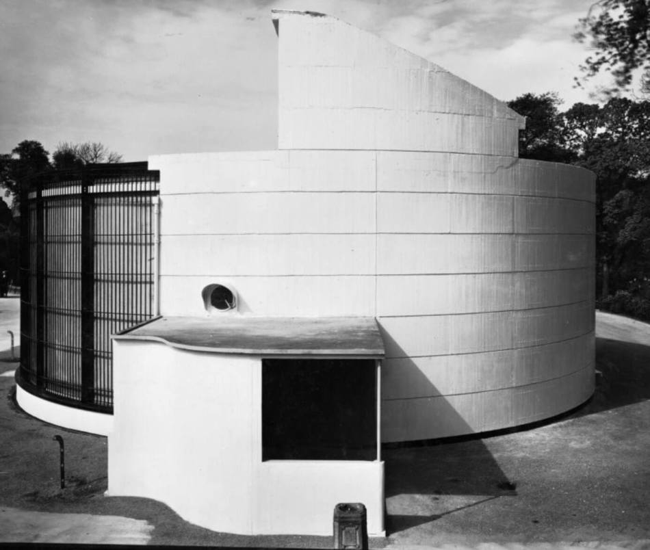 A black and white archive photograph of a zoo enclosure in a modernist style.