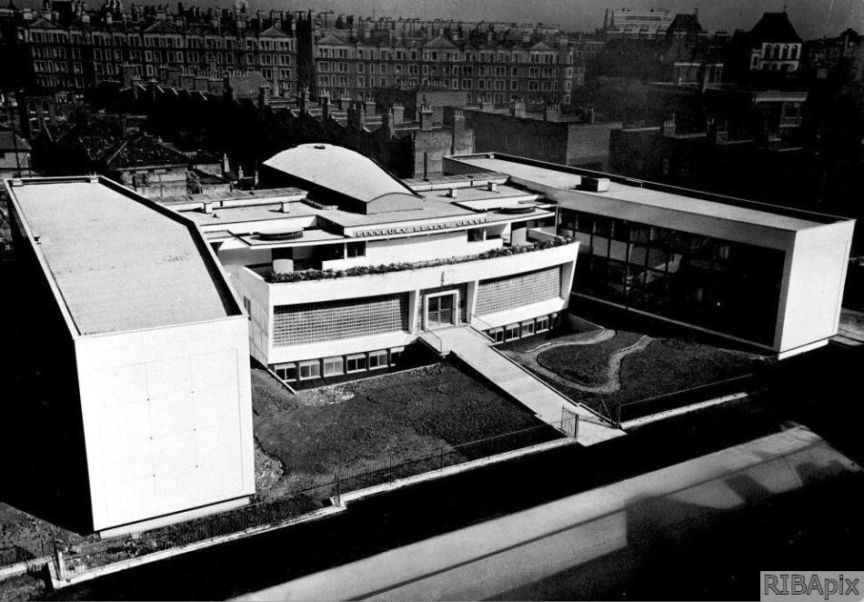 A black and white image of a health centre built in a modernist style to an "H"-shaped plan.