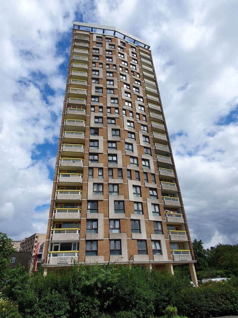 A colour photograph of a tall block of flats.