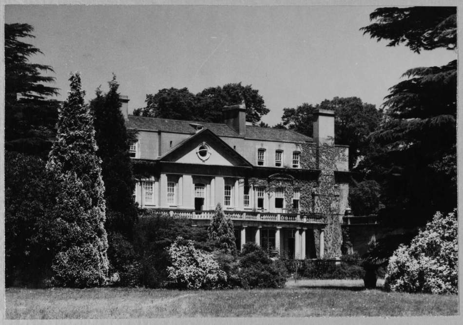 A black and white image of a country house and grounds.
