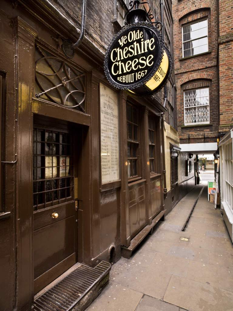 A photograph of a 17th century pub in an alleyway with a sign reading "Ye Olde Cheshire Cheese / REBUILT 1667".