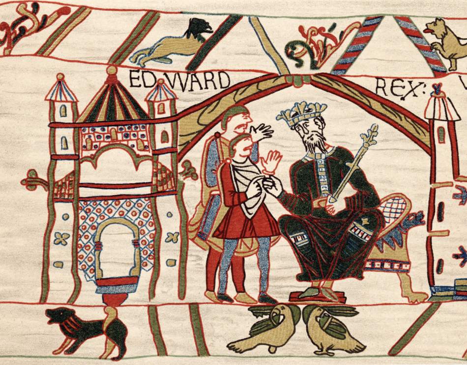 A photograph of a tapestry depicting a king on his throne, a castle, subjects and animals. 