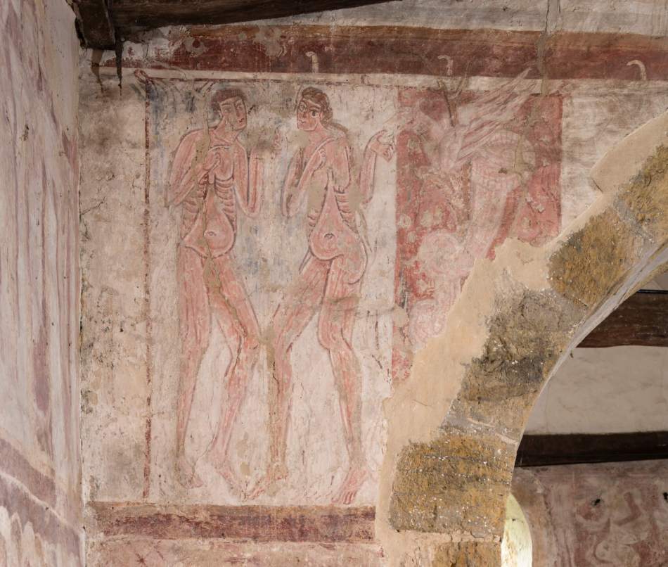 A photograph of a close up of a painting on a wall of a man and a woman.