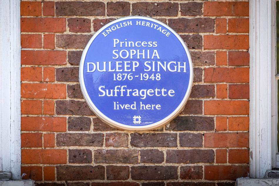 A close-up photograph of a blue plaque on the exterior of a brick wall of a building featuring the wording 'Princess Sophia Duleep Singh, 1876 - 1948, suffragette lived here'.