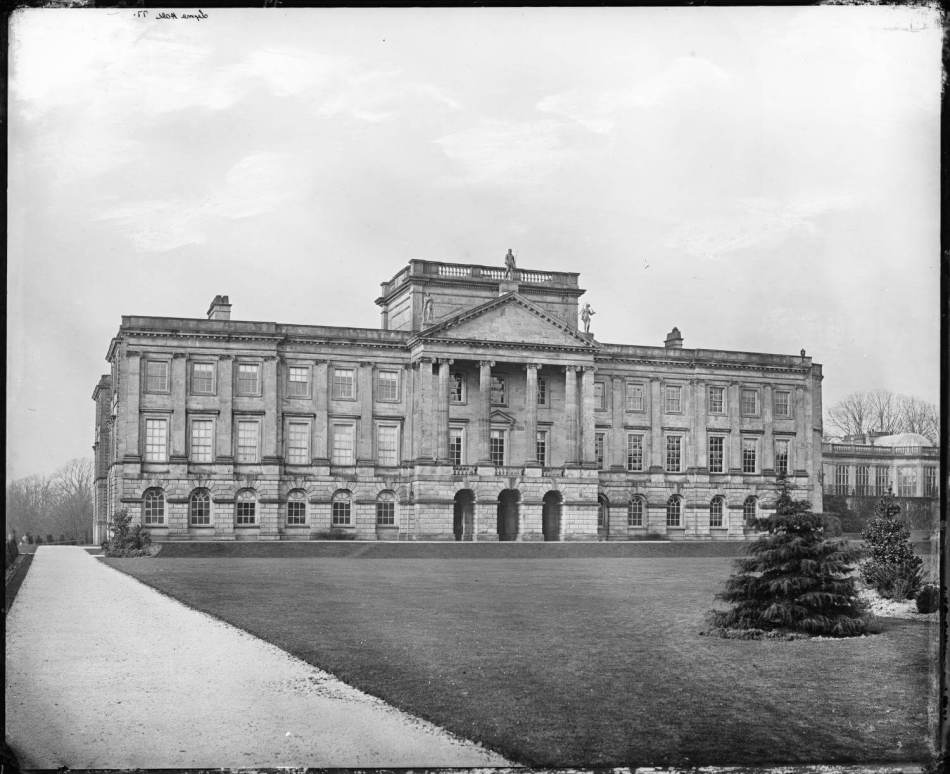 A black and white photograph of a large country house.