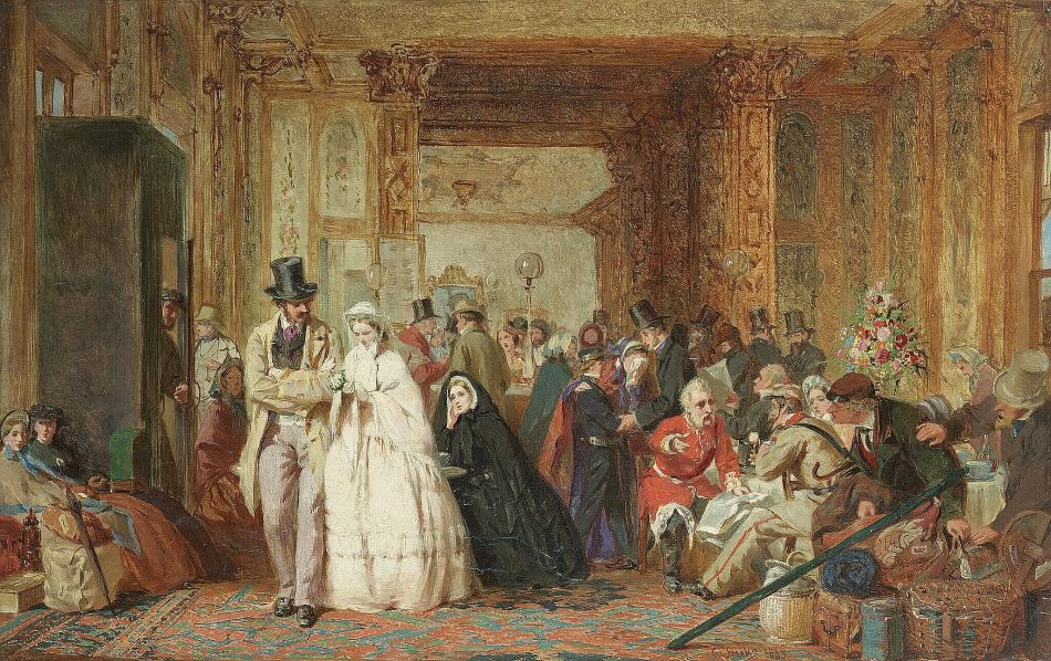 A painting of the interior of an ornate room at a railway station filled with people in Victorian dress sitting and talking, or walking, surrounded by luggage.