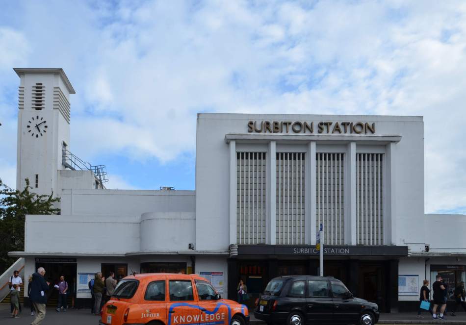 A photograph of the exterior of a small, Art Deco-style train station.