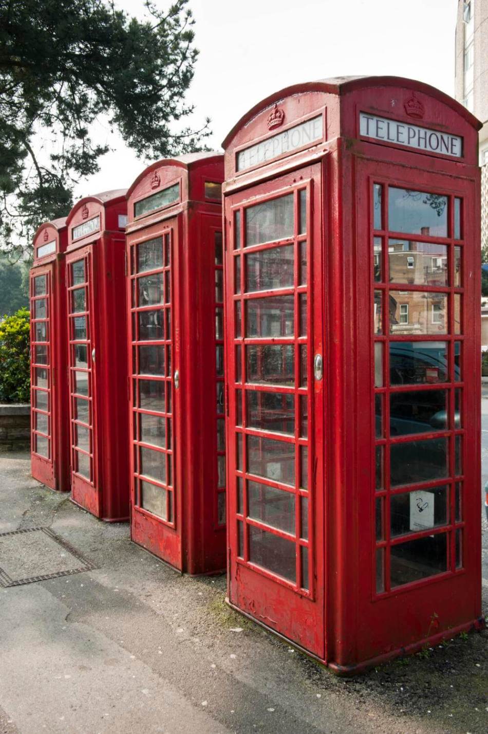 A photograph of a postcard of people standing on the steps leading to a large, ornate drinking fountain in the centre of a park.