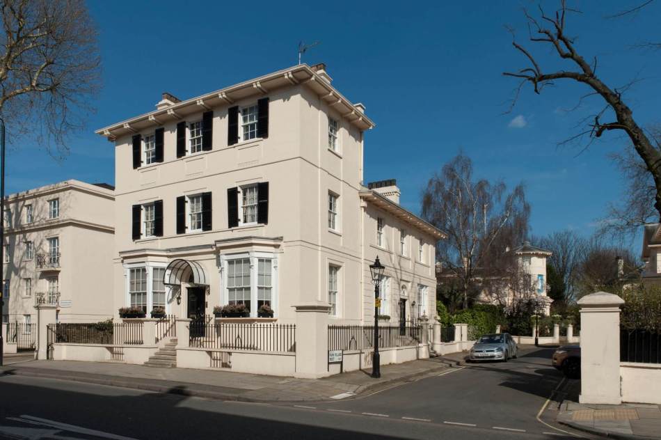 A photograph of the exterior of a 3-storey Georgian townhouse on the corner of road.