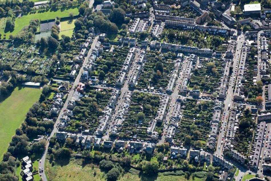 An aerial photograph of a suburban housing development in a grid format with long gardens.