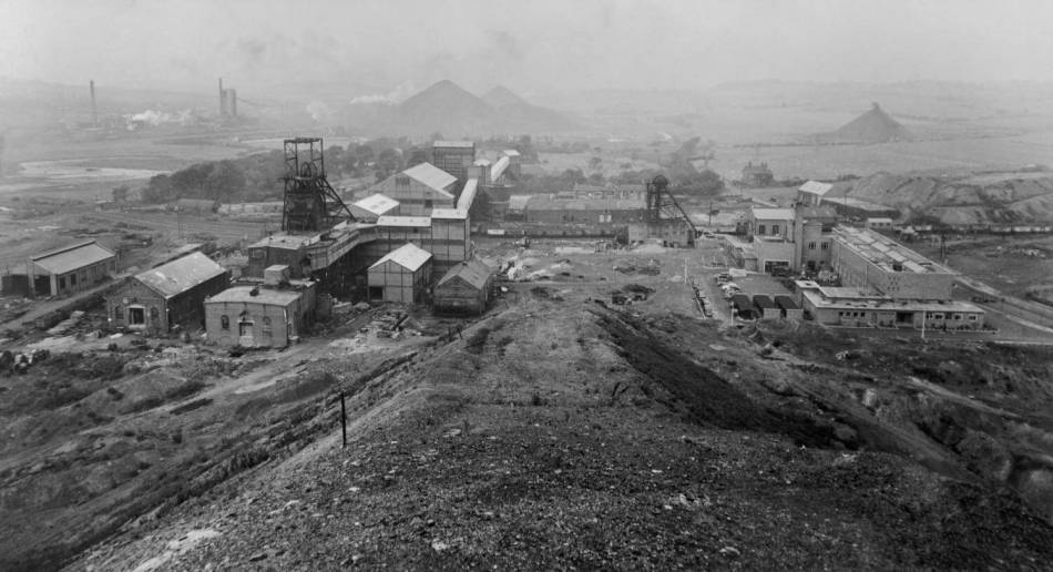 A black and white photograph of a colliery site. 