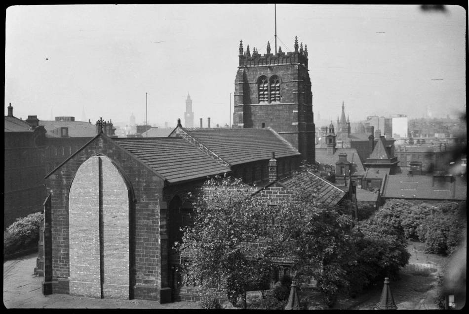 A black and white photograph of a cathedral with a small tower.
