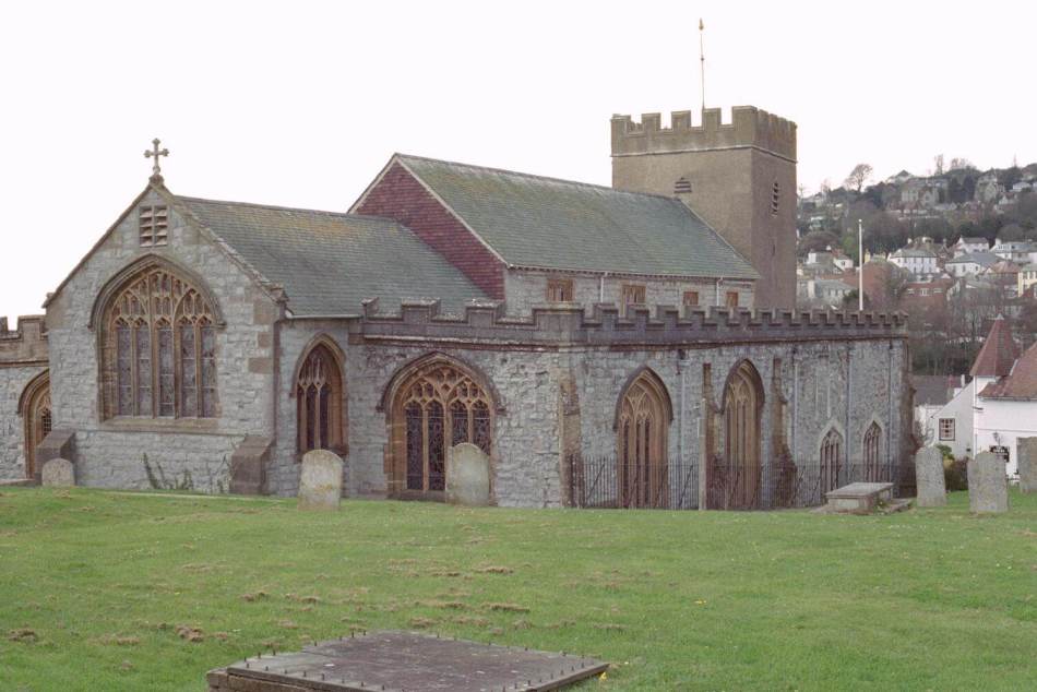 A photograph of the exterior of a church with grass in the foreground. 