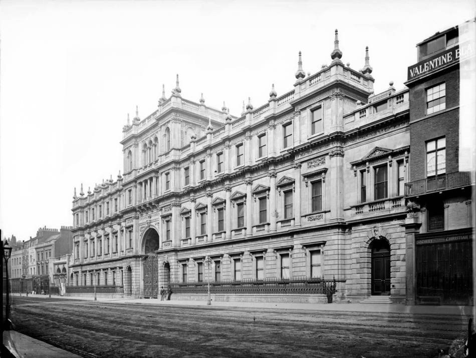 A black and white photograph of a large ornate building. 