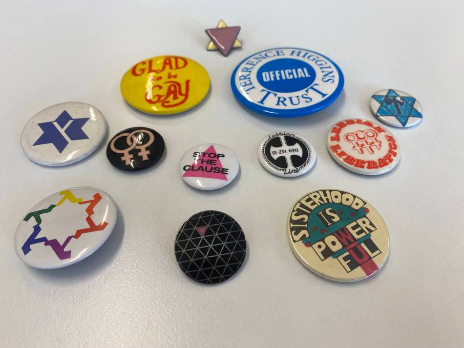 A photograph of a selection of pin badges.
