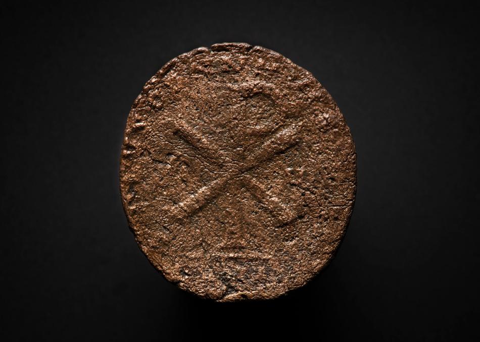 A roman coin with a Chi-Ro monogram formed from the letters of Christ's name in Greek.