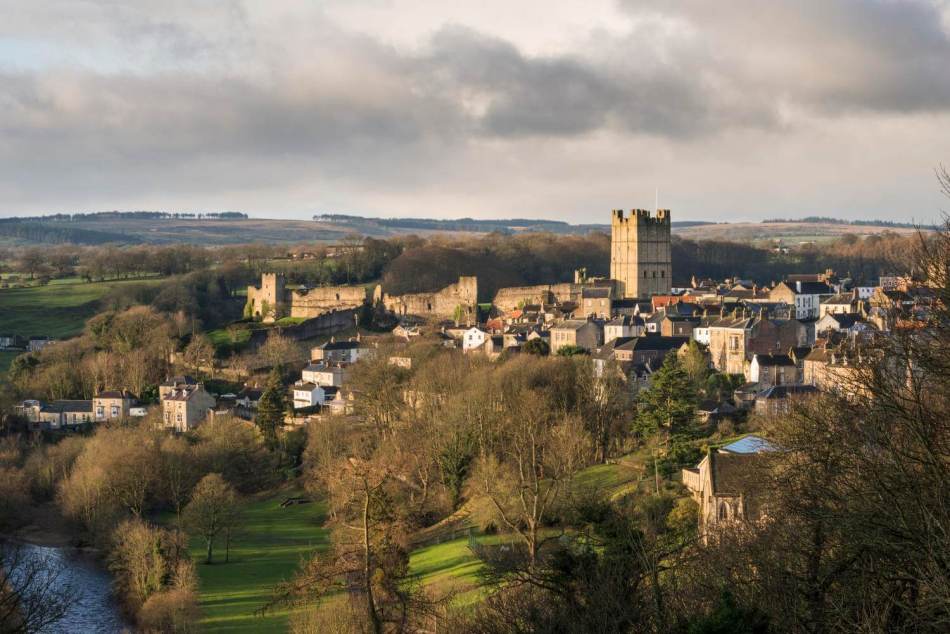 A photograph of a medieval castle and surrounding town.