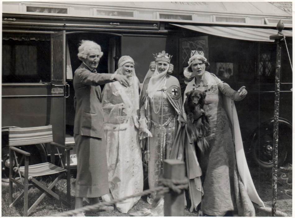 A black and white photograph of a group of women in historical costume. 