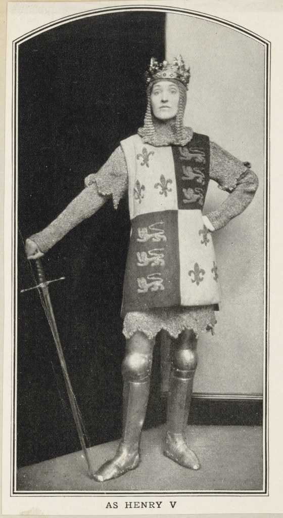 A photograph of a woman in a suit of armour and a crown. 