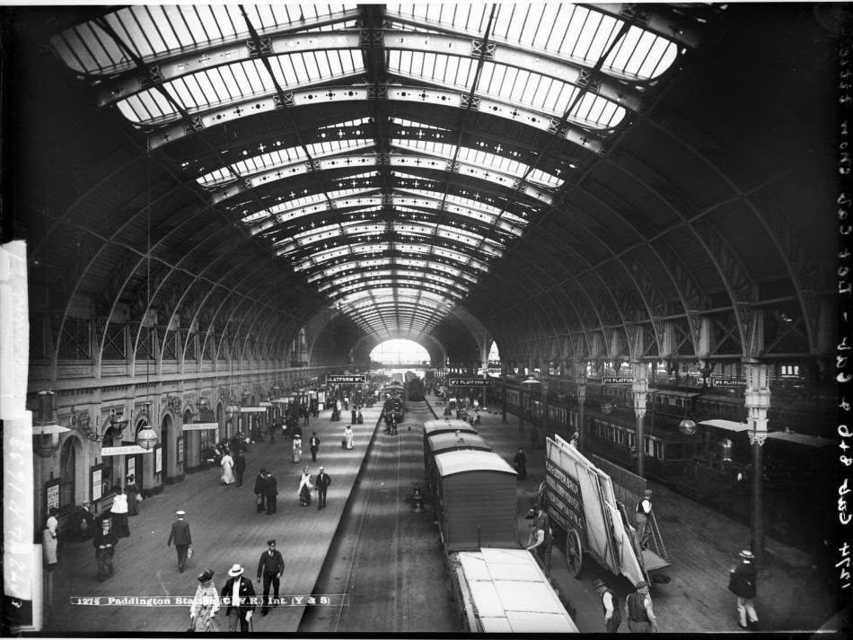 A black and white photograph of the interior of a train station.