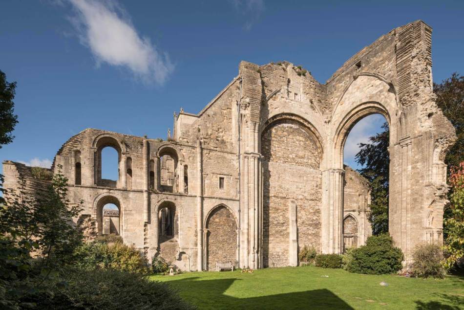 A photograph of the ruins of an abbey surrounded by trees.