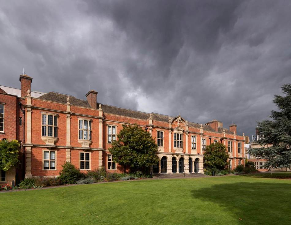 A photograph of a red brick two-storey grand building. 