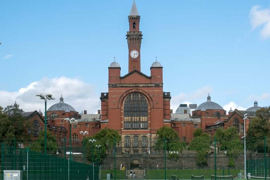 A photograph of a red brick university building.