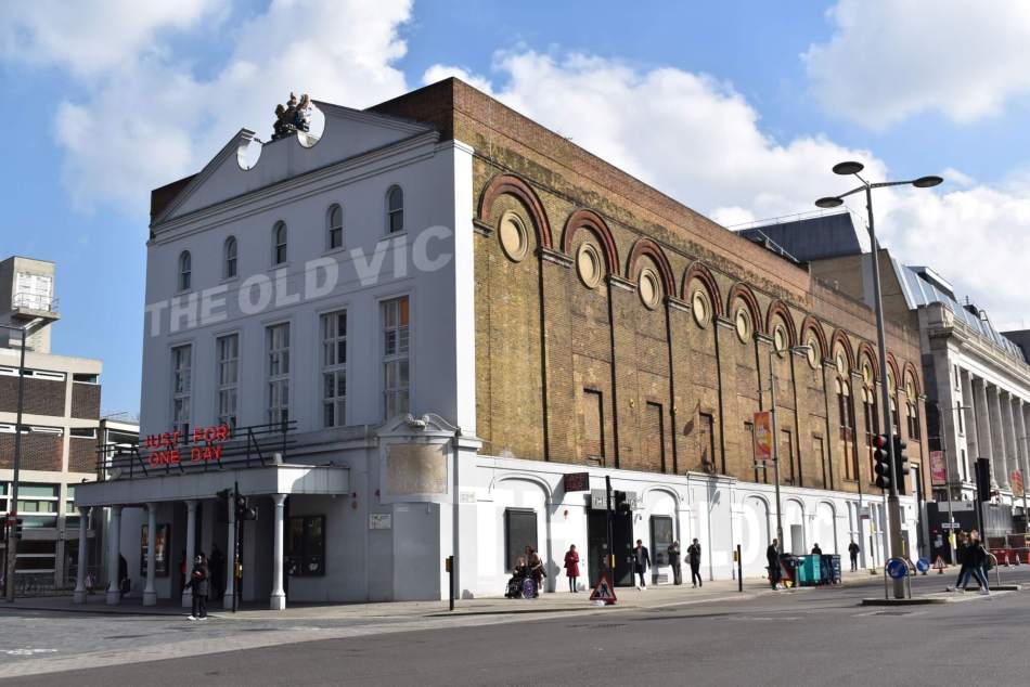 Large building of 3 storeys, with blind arcading on the side elevation. The 5-bay façade is rendered, with the words ‘The Old Vic’ painted across it.